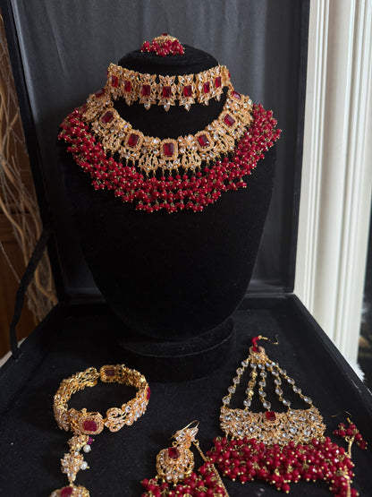 NIDA - Heavy bridal set includes: necklace, choker, jhumar, earrings, tikka and a hand piece (RED)